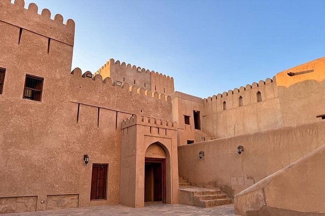 Amouage & Nizwa Full-Day Tour: Fort, Souq & Barakat Al Mouz - Inside Nizwa Fort, where the story gets physical