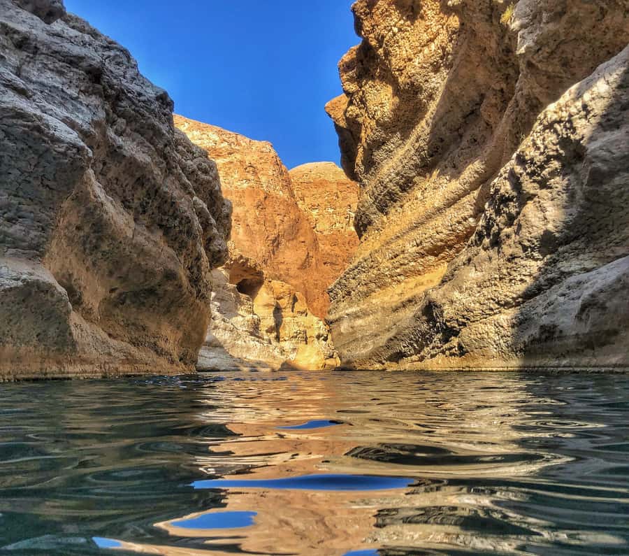From Muscat: Wadi Shab & Bimmah Sinkhole Full-Day Tour - Crossing the river and entering Wadi Shab