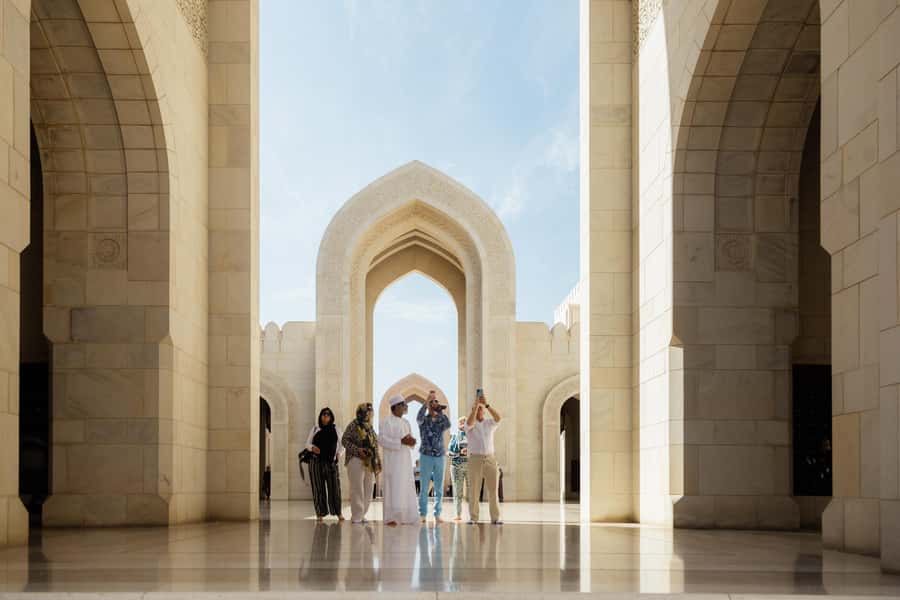 Guided Walking Tour of Sultan Qaboos Grand Mosque in Muscat - The entrance, minarets, and first view of the complex